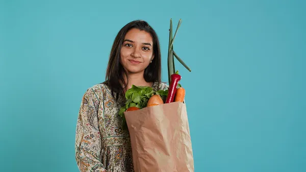 portrait-smiling-person-holding-bio-groceries-shopping-bag