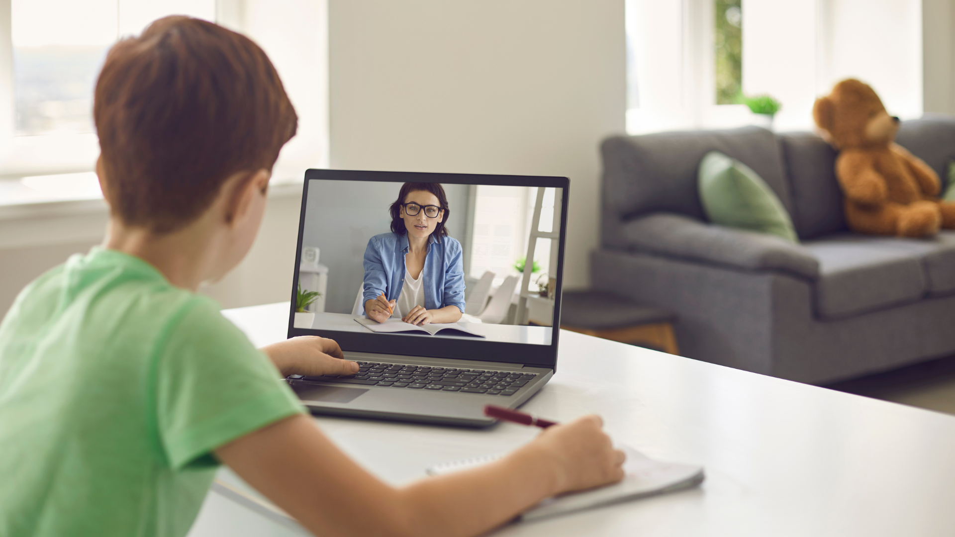 Young child learning online with a laptop using an interactive course on an online class website